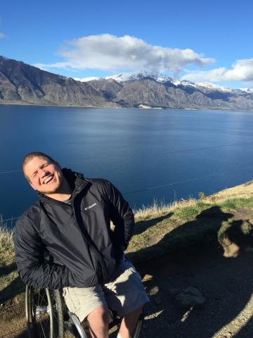 Tim in New Zealand with water and mountains in the background