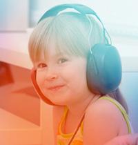 smiling 5-year-old-boy wearing headphones