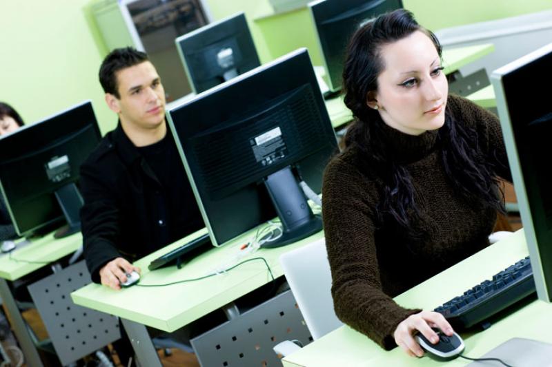 young man and young woman working on computers