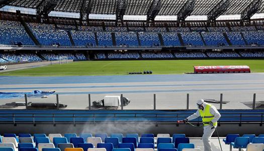 Worker clears debris from empty stadium