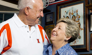Mary Henson and Lou Henson smiling at each other